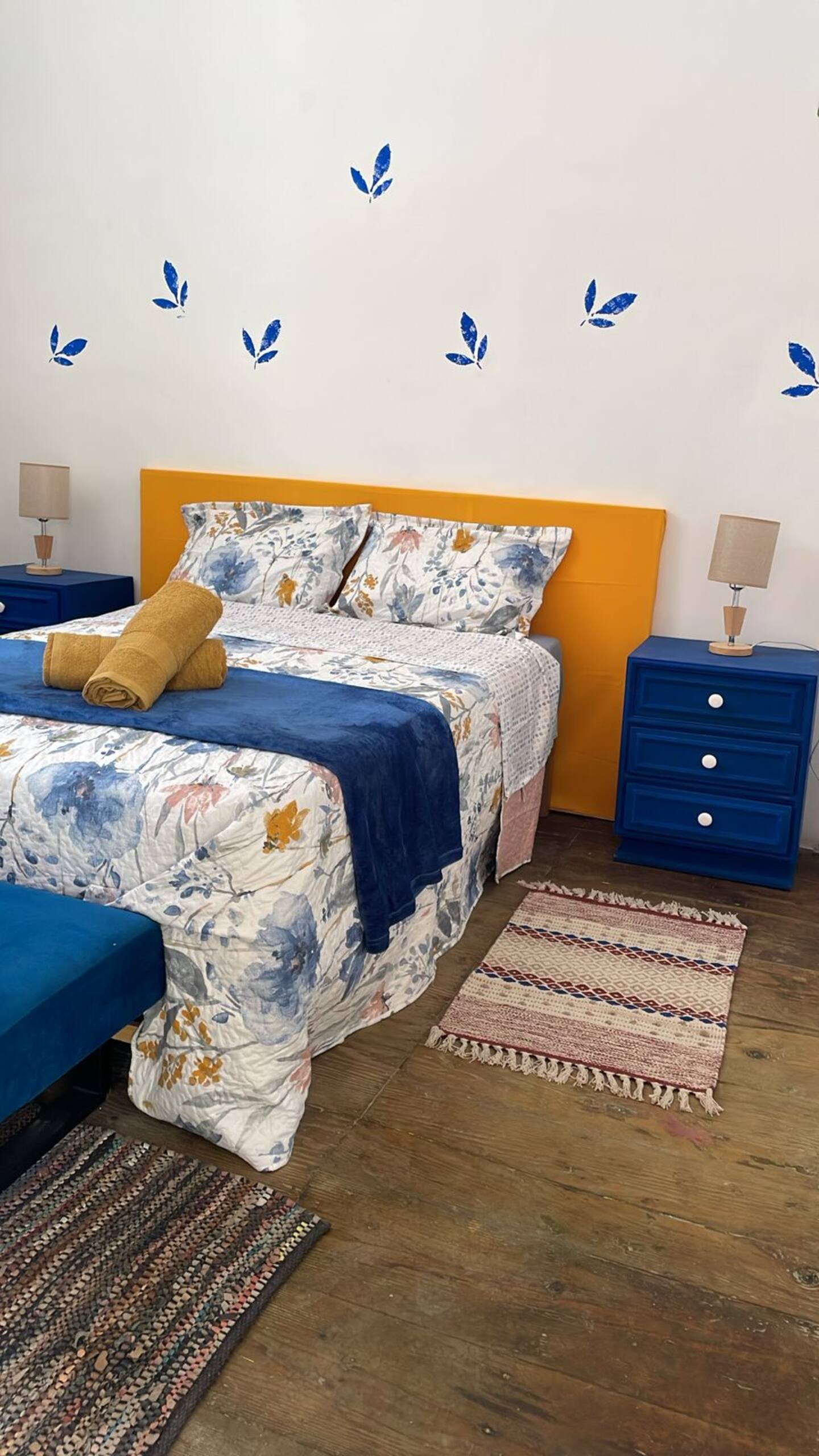 Comfortable bedroom with blue and yellow decor